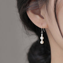 Load image into Gallery viewer, Asymmetrical surgical steel dangle earrings with 3mm and 6mm freshwater pearls, hypoallergenic and elegant.