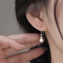 Load image into Gallery viewer, Asymmetrical surgical steel dangle earrings with 3mm and 6mm freshwater pearls, hypoallergenic and elegant.