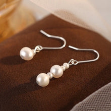 Load image into Gallery viewer, Asymmetrical surgical steel dangle earrings with 3mm and 6mm freshwater pearls, hypoallergenic and elegant.