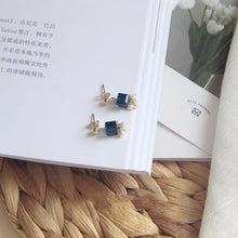 Load image into Gallery viewer, A pair of stud earrings featuring 6mm sugar blue Austrian crystal cubes paired with 2-3mm freshwater baroque pearls, showcasing a whimsical and elegant design.