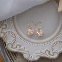 Load image into Gallery viewer, Nickel-free gold dangle earrings with 3-4mm baroque pinkish-orange peach freshwater pearls in a wire-wrapped design.