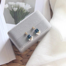 Load image into Gallery viewer, A pair of stud earrings featuring 6mm sugar blue Austrian crystal cubes paired with 2-3mm freshwater baroque pearls, showcasing a whimsical and elegant design.