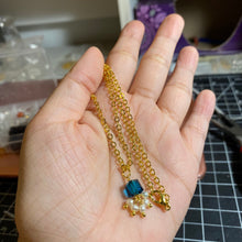 Load image into Gallery viewer, A pair of stud earrings featuring 6mm sugar blue Austrian crystal cubes paired with 2-3mm freshwater baroque pearls, showcasing a whimsical and elegant design.