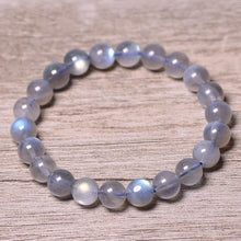 Load image into Gallery viewer, A bracelet made of AAA labradorite round beads in 6mm and 8mm sizes, showcasing stunning iridescence and color play, with a stretchy design for a comfortable fit.