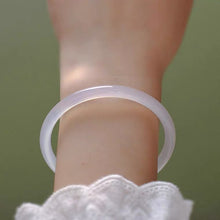 Load image into Gallery viewer, A thin, small bangle made of translucent natural white agate gemstone, available in 54mm, 56mm, and 58mm sizes, showcasing a delicate and sophisticated glow.