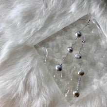 Load image into Gallery viewer, A pair of earrings featuring 4mm black peacock baroque natural pearls, wire-wrapped and dangling from a 10cm drop, designed for a sophisticated look