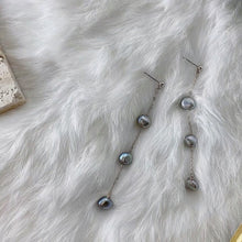 Load image into Gallery viewer, A pair of earrings featuring 4mm black peacock baroque natural pearls, wire-wrapped and dangling from a 10cm drop, designed for a sophisticated look