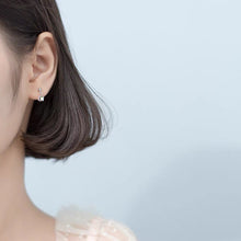 Load image into Gallery viewer, Tiny stud earrings made of surgical steel, featuring 6mm and 8mm clear AB rainbow sugar cube beads, showcasing a minimalist design with a pop of color.