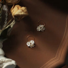 Load image into Gallery viewer, 18K gold-plated earrings with 10mm mother of pearl three-petal flower design. Perfect for weddings, bridal parties, and bridesmaid gifts.