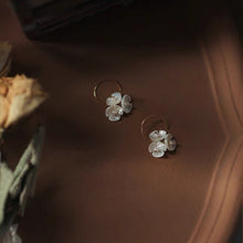 Load image into Gallery viewer, 18K gold-plated earrings with 10mm mother of pearl three-petal flower design. Perfect for weddings, bridal parties, and bridesmaid gifts.
