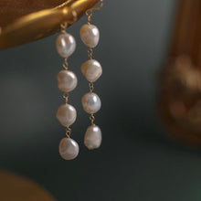 Load image into Gallery viewer, 18K gold-plated dangle earrings with 10mm natural Keshi pearls. Ideal for weddings and bridesmaid gifts, offering a touch of elegance and sophistication.
