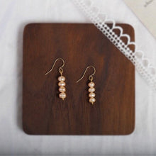 Load image into Gallery viewer, A pair of small earrings plated with 18K gold, featuring two 4mm peach baroque freshwater pearls on a bar.
