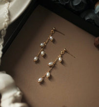 Load image into Gallery viewer, 18K gold plated or surgical steel stud earrings with 4mm oval rice pearls in a flora style design, perfect for adding a touch of sophistication to any outfit.