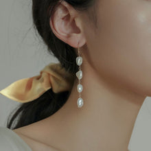 Load image into Gallery viewer, 18K gold-plated dangle earrings with 10mm natural Keshi pearls. Ideal for weddings and bridesmaid gifts, offering a touch of elegance and sophistication.