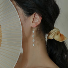 Load image into Gallery viewer, 18K gold-plated dangle earrings with 10mm natural Keshi pearls. Ideal for weddings and bridesmaid gifts, offering a touch of elegance and sophistication.