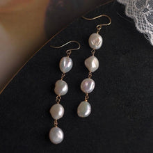 Load image into Gallery viewer, 18K gold-plated dangle earrings with 10mm natural Keshi pearls. Ideal for weddings and bridesmaid gifts, offering a touch of elegance and sophistication.