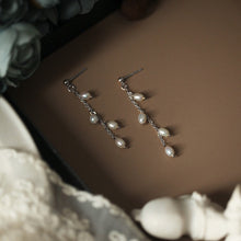 Load image into Gallery viewer, 18K gold plated or surgical steel stud earrings with 4mm oval rice pearls in a flora style design, perfect for adding a touch of sophistication to any outfit.