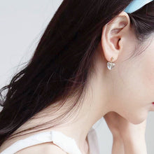 Load image into Gallery viewer, 18K gold plated or surgical steel earrings with 8mm clear AB love heart rainbow glass colored glaze lampwork beads, perfect for adding a touch of whimsy and charm to any outfit.