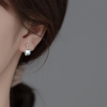 Load image into Gallery viewer, Tiny stud earrings made of surgical steel, featuring 6mm and 8mm clear AB rainbow sugar cube beads, showcasing a minimalist design with a pop of color.