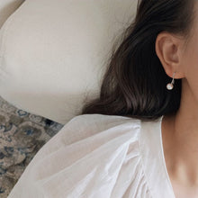 Load image into Gallery viewer, 18K gold plated or steel dangle earrings with 8-8.5mm freshwater AAA off round white pearls, perfect for adding a touch of timeless beauty and sophistication to any outfit.