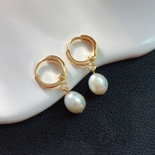 Load image into Gallery viewer, Hoop earrings plated with 18K gold, featuring 5-6mm AAA oval light pearls in white, peach, and purple colors, with a lever back huggie style.