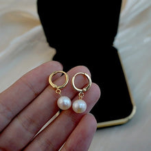Load image into Gallery viewer, 18K gold plated huggie earrings with off-round AAA-grade 7mm freshwater pearls, perfect for adding a touch of elegance to any outfit.
