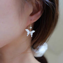Load image into Gallery viewer, 18K gold plated or surgical steel earrings with a 16mm natural mother of pearl butterfly design and AAA 4mm pearls, perfect for a wedding gift or special occasion.