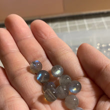 Load image into Gallery viewer, A bracelet made of AAA labradorite round beads in 6mm and 8mm sizes, showcasing stunning iridescence and color play, with a stretchy design for a comfortable fit.