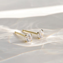 Load image into Gallery viewer, A pair of 14K solid gold stud earrings with cubic zirconia stones available in 3mm, 4mm, and 5mm sizes.
