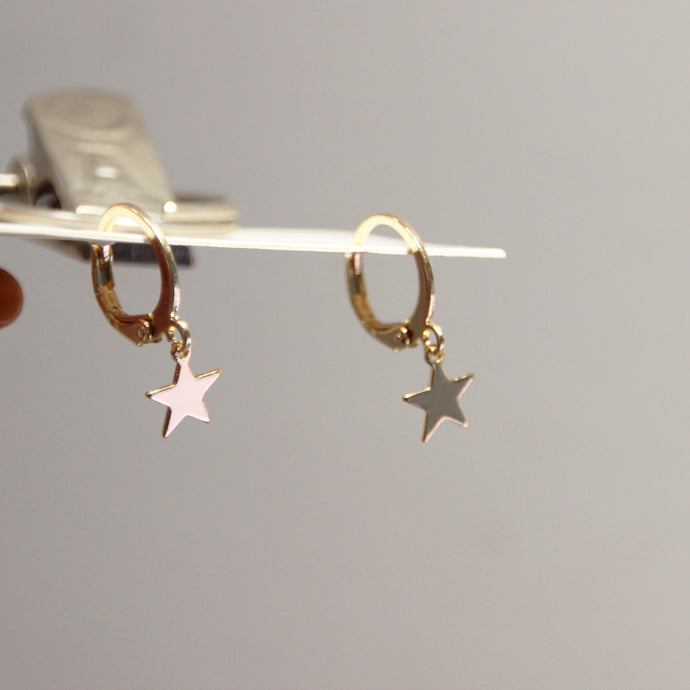 Gold-plated hoop earrings with 10mm star charms, stylish and versatile for any occasion.