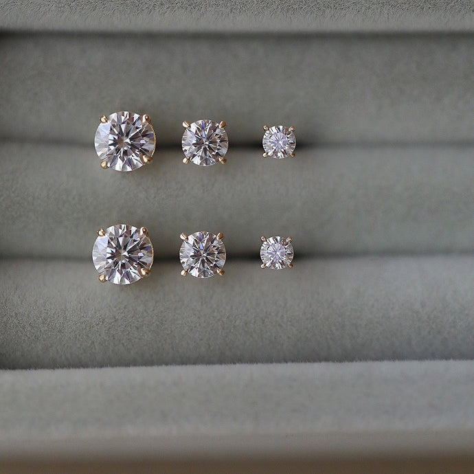 A pair of 14K solid gold stud earrings with cubic zirconia stones available in 3mm, 4mm, and 5mm sizes.