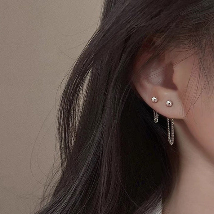 Asymmetrical Korean fashion stud earrings with a 2cm stud and a 3cm chain detail, made from high-quality steel. Inspired by K-Pop star style.