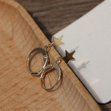 Load image into Gallery viewer, Gold-plated hoop earrings with 10mm star charms, stylish and versatile for any occasion.
