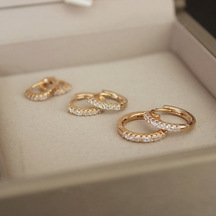 A trio of 18K Gold Plated S925 Huggies in 8mm, 10mm, and 12mm sizes, made from sterling silver and plated with 18K gold.