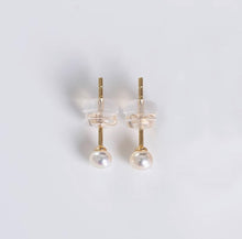 Load image into Gallery viewer, A pair of 14K solid gold earrings featuring lustrous AAA-grade button freshwater pearls, known for their exceptional quality and shine.
