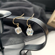 이미지를 갤러리 뷰어에 로드 , A pair of 18K gold plated dangle earrings featuring 6mm sugar cube clear AB beads with an iridescent finish.
