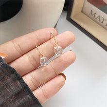 이미지를 갤러리 뷰어에 로드 , A pair of 18K gold plated dangle earrings featuring 6mm sugar cube clear AB beads with an iridescent finish.
