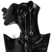 Load image into Gallery viewer, A pair of silver hoop earrings with a chain of moving beads, measuring 5cm in length. The earrings have a punk-inspired design with a double-piercing style.
