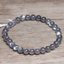 Load image into Gallery viewer, A bracelet made of AAA labradorite round beads in 6mm and 8mm sizes, showcasing stunning iridescence and color play, with a stretchy design for a comfortable fit.
