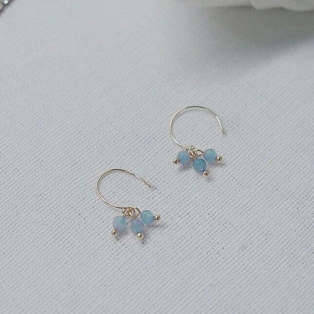 18K gold-plated dangle earrings with 4mm faceted light blue aquamarine beads. Elegant and sophisticated, perfect for adding a touch of sparkle to your look.