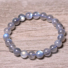 Load image into Gallery viewer, A bracelet made of AAA labradorite round beads in 6mm and 8mm sizes, showcasing stunning iridescence and color play, with a stretchy design for a comfortable fit.
