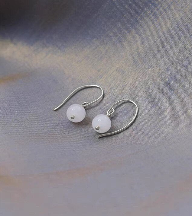 18K gold plated or silver dangle earrings with 6mm white jade round beads, perfect for adding a touch of understated elegance to any outfit.