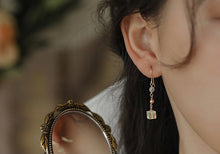 Load image into Gallery viewer, A pair of 18K Gold Plated steel earrings with 6mm clear AB sugar cube beads.
