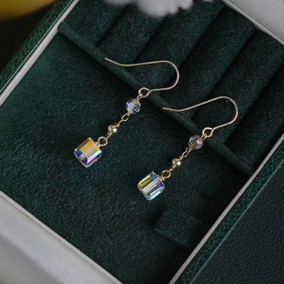 A pair of 18K Gold Plated steel earrings with 6mm clear AB sugar cube beads.