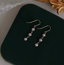 Load image into Gallery viewer, 18K gold plated, silver, or surgical steel dangle earrings with 4mm baroque pearls, perfect for adding an organic and elegant touch to any outfit.
