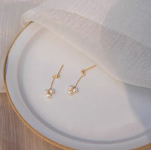 Load image into Gallery viewer, 18K gold plated or steel dainty stud earrings with 3-4mm natural pearls and a chain, perfect for adding a touch of sophistication to any outfit.
