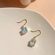 이미지를 갤러리 뷰어에 로드 , A pair of 18K gold plated dangle earrings featuring 6mm sugar cube clear AB beads with an iridescent finish.
