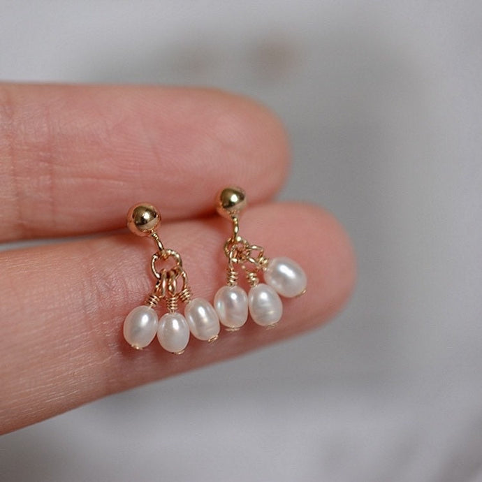 A pair of 18K Gold Plated or surgical steel stud earrings with AAA 4-5mm small oval natural pearls.