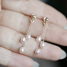 Load image into Gallery viewer, A pair of 18K Gold Plated or surgical steel earrings with 4-5mm oval AAA freshwater pearls, 5cm in length, ideal for wedding bridal and bridesmaid gifts.
