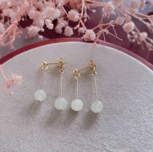 Load image into Gallery viewer, A pair of 18K gold plated earrings featuring 6mm small natural white jade stones, measuring between 4.5 to 5cm in length.
